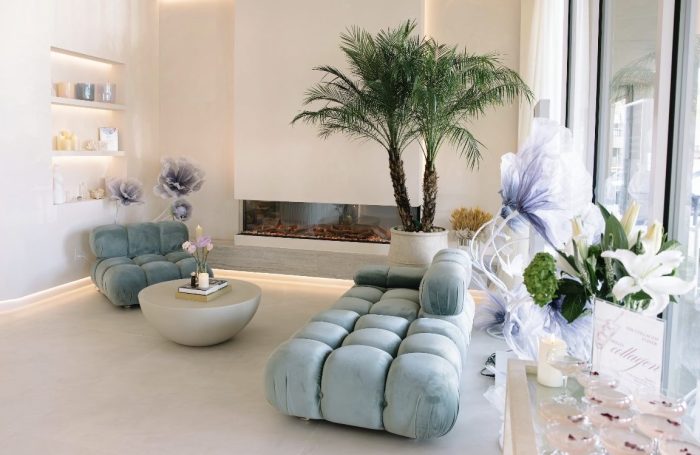 The waiting area of SENSE+ features real trees and light blue sofas.
