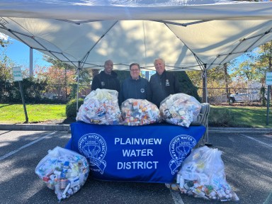 Nassau County Police Officer Kenneth Brown with Plainview Water District Commissioner Andrew Bader and Commissioner Michael Chad (L. to R.) at the eighth annual Pharmaceutical Take Back Day event.