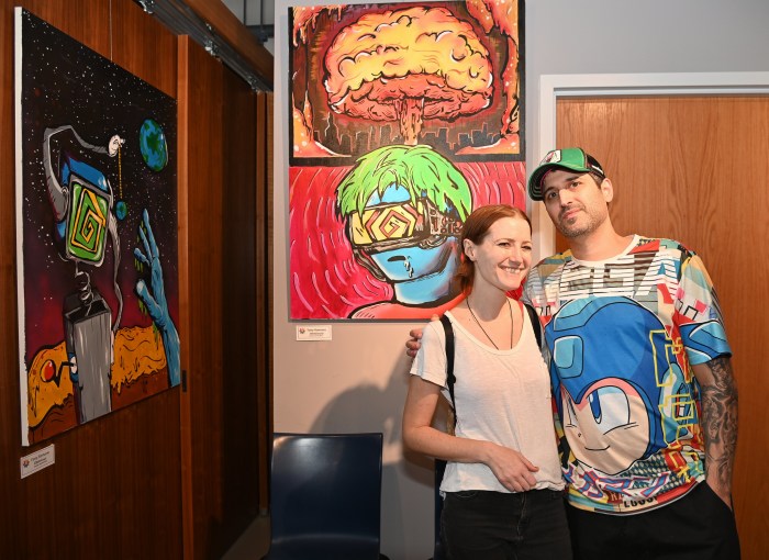 Sarah Rohrs and Tony Romano with his artwork Immersed – Acrylic.
