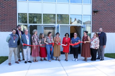 Glen Cove Board of Education Vice President Anne Markoulis, President Angela Riamo and Superintendent Alexa Doescher (C.) cut the ribbon on the new extension at Landing School.