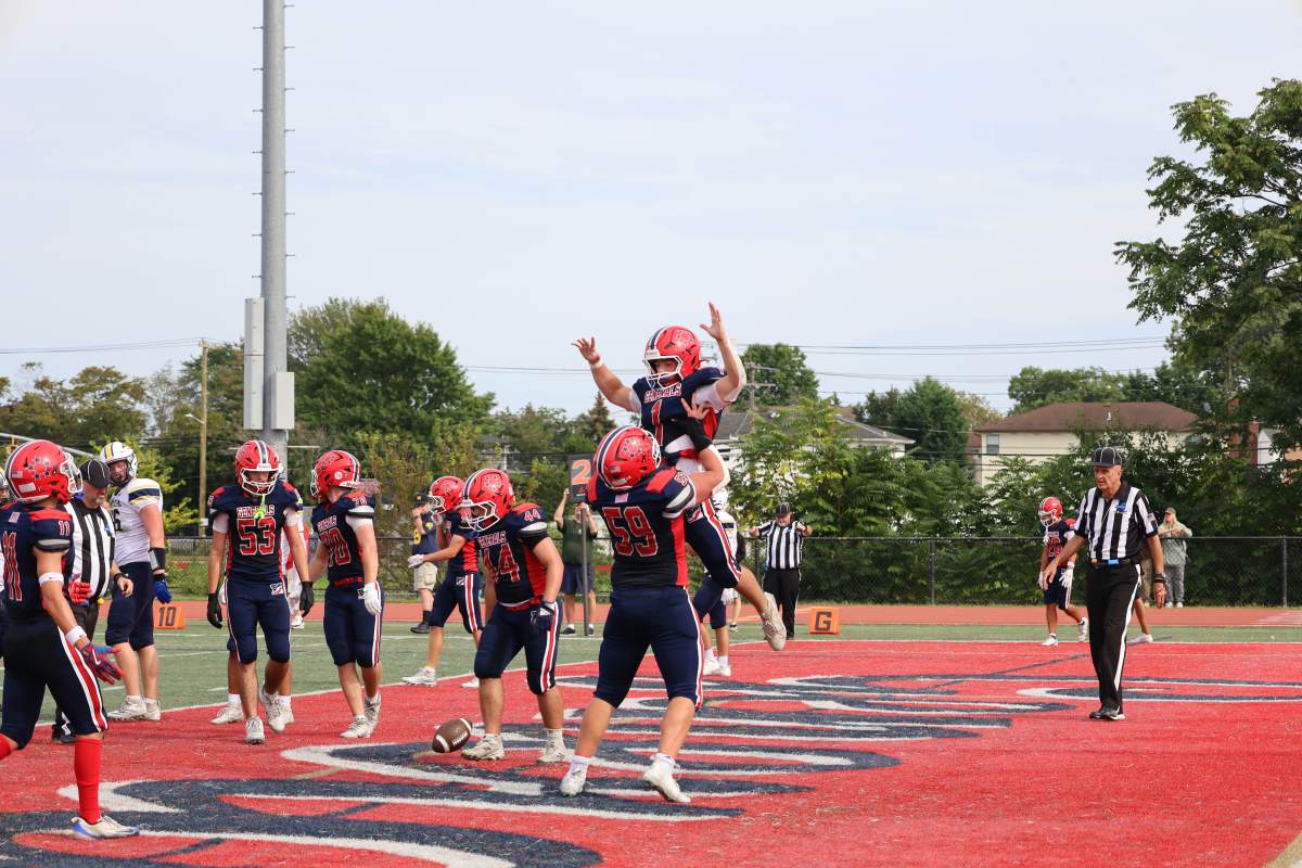Members of the MacArthur High School varsity football team cheered after a touchdown during the homecoming game against Jericho High School