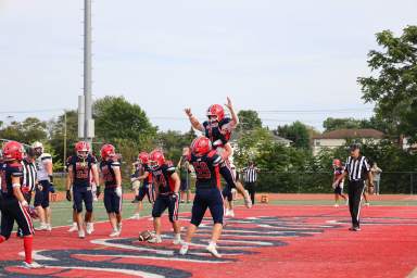 Members of the MacArthur High School varsity football team cheered after a touchdown during the homecoming game against Jericho High School