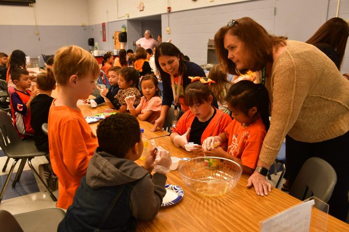 Students making zucchini bread with their teacher.