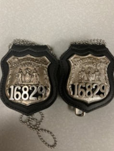 One of the several items found in Denton's car was a police badge.