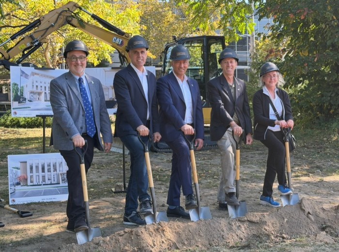 The Village of Great Neck board of trustees posed with hard hats and shovels at the ground breaking ceremony.