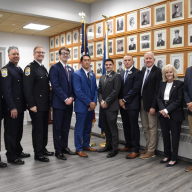 (L.) to (R.) Port Washington Police District Chief Robert Del Muro, Deputy Chief William Zwerlein, Assistant Chief Kevin McCarroll, PWPD recruits Marsigliano, Caruso, Guzzello, Betsch, PWPD Commissioners Sean McCarthy, Angela Lawlor-Mullins and JB Meyer.