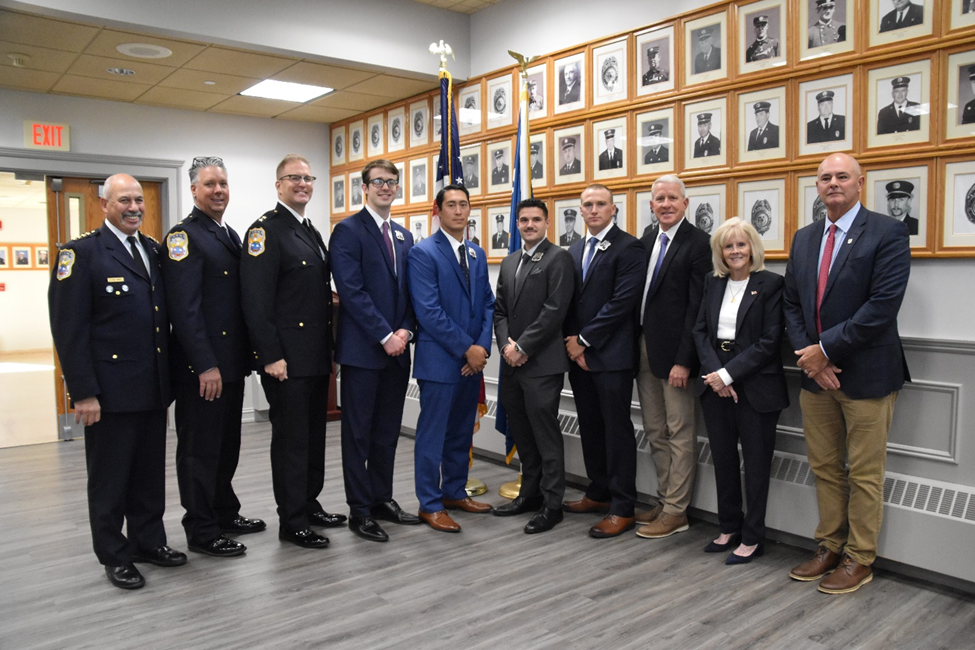 (L.) to (R.) Port Washington Police District Chief Robert Del Muro, Deputy Chief William Zwerlein, Assistant Chief Kevin McCarroll, PWPD recruits Marsigliano, Caruso, Guzzello, Betsch, PWPD Commissioners Sean McCarthy, Angela Lawlor-Mullins and JB Meyer.