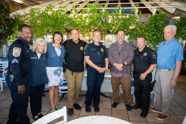 Port Washington residents chat with local officers during National Coffee with a Cop Day at Ayhan’s Mediterranean Marketplace.