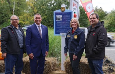 Oyster Bay Town Supervisor Joseph Saladino (second from L.) and Council Member Laura Maier unveil a historical sign commemorating more than 200 years of business at the Jericho Cider Mill, with owners Ted (L) and Kerry (R) Ketsoglou.