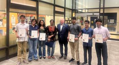Arnold Drucker (C.) awards Plainview-Old Bethpage, Syosset, and Jericho students with citations for their environmental activism