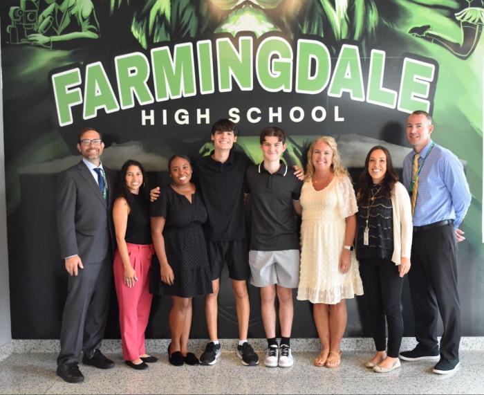Farmingdale High School principal Jed Herman, assistant principal Arlene Martinez, guidance counselor Nyquasha Bruzzone, valedictorian Nicholas Zito, salutatorian Anthony McKee, guidance counselor Lisa Jensen, assistant principal Carla Stillwell, and assistant principal Christopher Patronaggio (L. to R.).