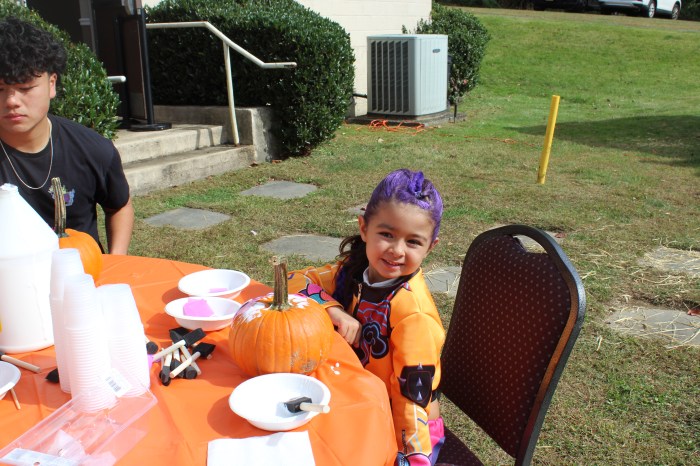 Children spent time decorating pumpkins that they picked from a pumpkin patch.