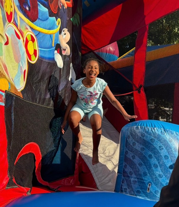 Children enjoyed bounce houses and slides at the street fair. 