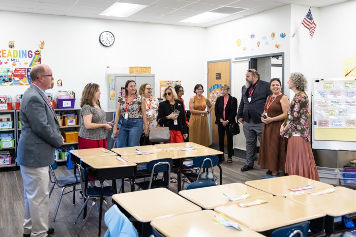 District officials tour the new classrooms at Landing School, alongside Mayor Pam Panzenbeck (C.).
