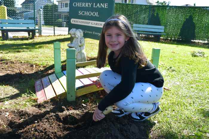 Students placed flowers at the Frendship Garden.