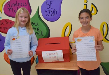 Forest Lake Elementary School fifth graders Aubrey Cook (L.), and Mia Bewick (R.) organized a project to write letters and make cards for local firefighters.