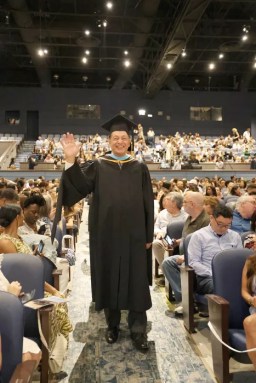 Hank Grishman walks into his final commencement ceremony as superintendent.