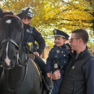 Children petted police horses at the Floral Park Police Department's Halloween event.