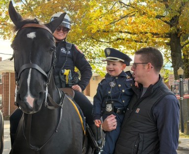 Children petted police horses at the Floral Park Police Department's Halloween event.