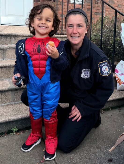 Officer Kelly Murphy welcomed children to the Halloween event by offering candy and snacks.