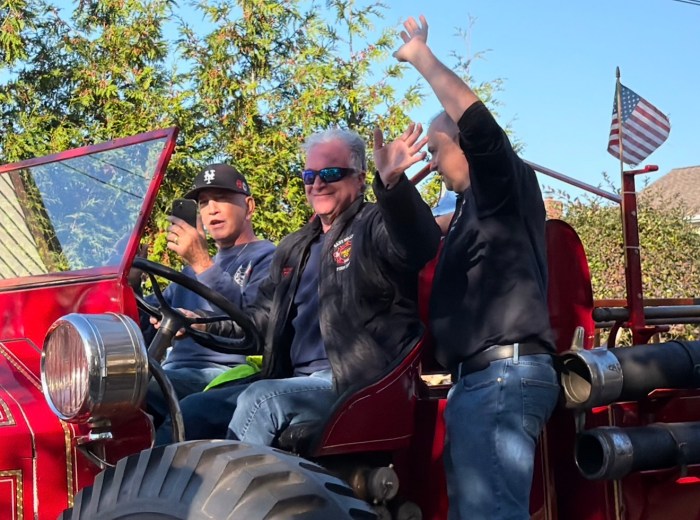 Parade participants waved to onlookers from their vehicles.