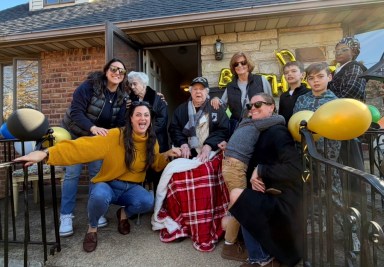 Sgt. Anthony Catalano, 105, posed with family and community members following a birthday parade.