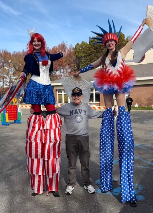 United States Navy veteran Peter Ciraulo posed with stilts performers at the Town of North Hempstead’s annual Thank You to Our Veterans event.