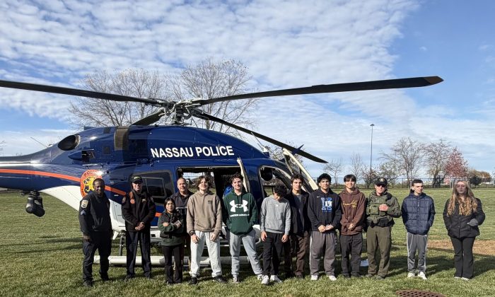 High school students with a Nassau County Police helicopter. 