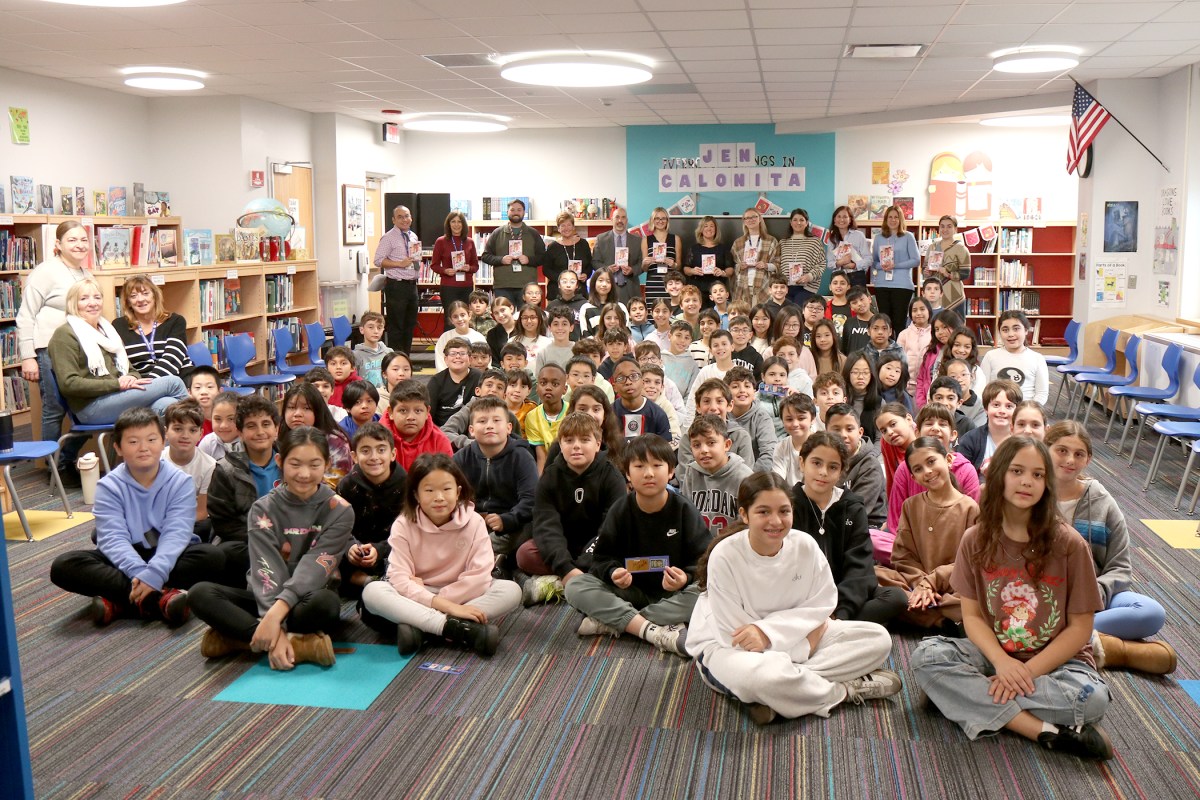 Principal Ron Gimondo and library media specialist Erin Vargo joined fifth grade students and their teachers during a visit from guest author Jen Calonita in the JFK library.
