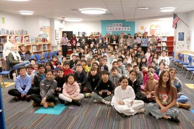 Principal Ron Gimondo and library media specialist Erin Vargo joined fifth grade students and their teachers during a visit from guest author Jen Calonita in the JFK library.