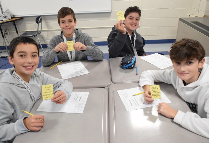 Sixth graders Tommy Dolan, Andrew Venditto, Bryan Hoffmans (L. to R.) and NicholasSantopietro received kindness cards to put in their ID holders.