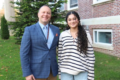 Senior Charlotte Nerayoff was congratulated by North High principal Corey McNamara.