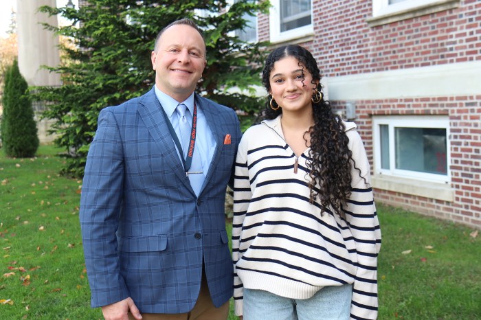 Senior Charlotte Nerayoff was congratulated by North High principal Corey McNamara.