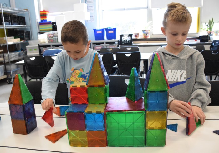 Luke Vespertino (L.), and James McDonald used Magna-Tiles to make buildings to go beside the parade route.