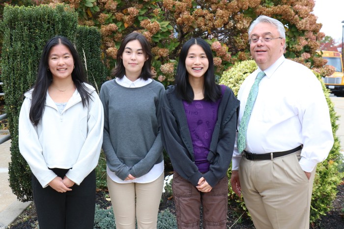 Seniors Emma Ding, Madeleine Lennox, and Julia Xu were congratulated by South High principal Thomas DePaola.