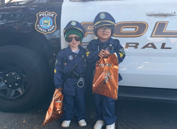 Attendees Leo, 2, and Jack, 3, posed in front of a police car. 