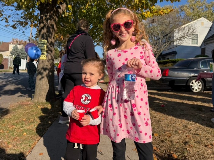 Ella and Sophia, Catalano's great great great nieces, watched the parade from outside his home.