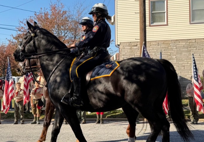 Mounted police officers passed Catalano's home as Boy Scout troops waved American flags.