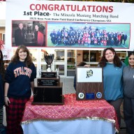 Mineola Marching Band Drum and Flag Majors with NYSFBC championship trophy (L-R): Madison DeCillis, Keira Faley, Mary Elias, Sarah Geoghan, Simranjot Singh and Madeleine Christianson.