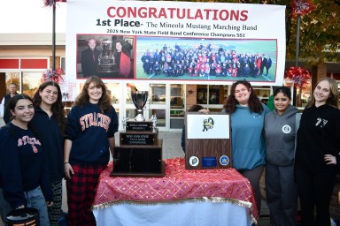 Mineola Marching Band Drum and Flag Majors with NYSFBC championship trophy (L-R): Madison DeCillis, Keira Faley, Mary Elias, Sarah Geoghan, Simranjot Singh and Madeleine Christianson.