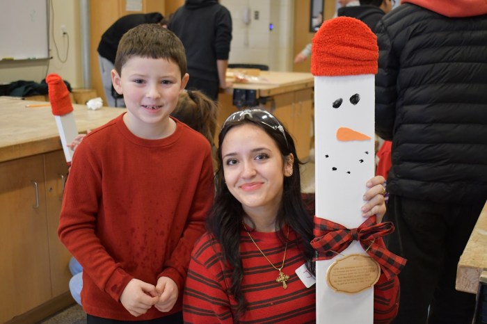 High school students made the snowmen the same height as the young students.