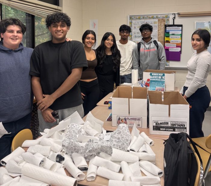 Herricks High School students prepare donated eyeglasses for shipment to aRwandan orphanage.