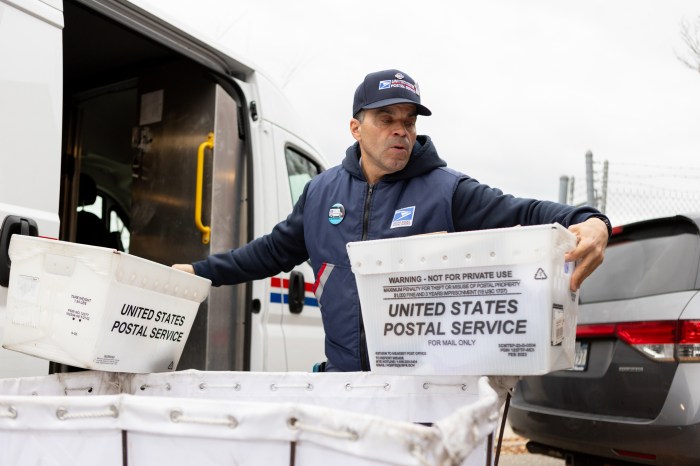 Morales sorting through mail before starting his route.