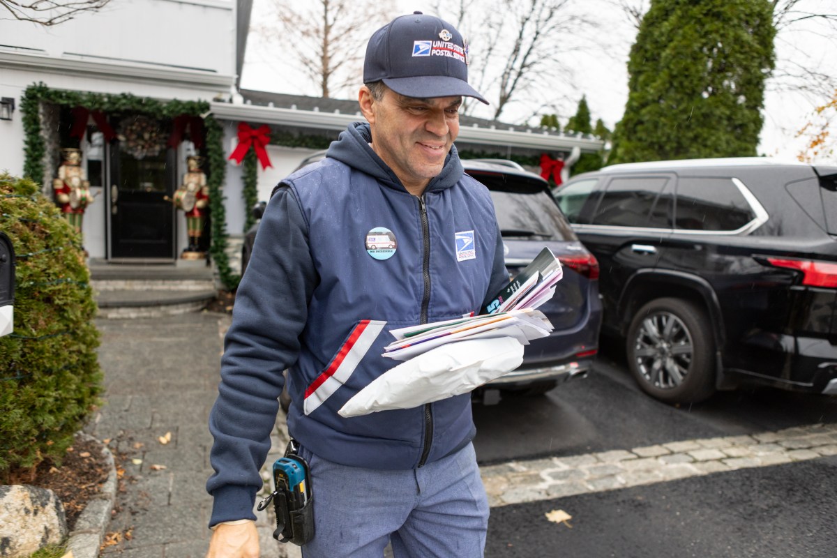 Port Washington Letter Carrier Richard Morales delivering mail during the holiday season.