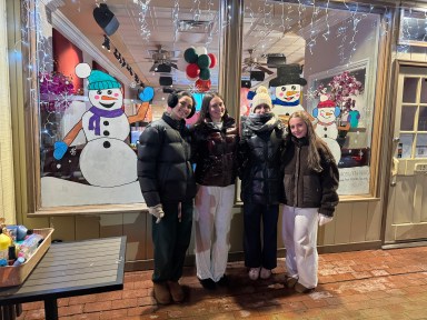 Roslyn High School art students in front of their winter wonderland window.