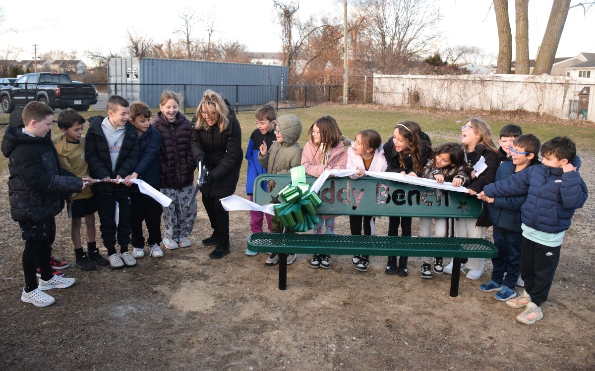 Seaford Harbor Elementary School second grade teacher Deirdre Baldassarre cut the ribbon on the new buddy bench, along with her students from the 2024-2025 school year, who came up with the idea during a persuasive writing unit.