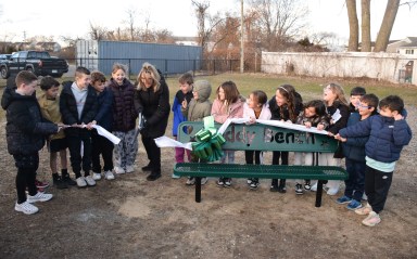 Seaford Harbor Elementary School second grade teacher Deirdre Baldassarre cut the ribbon on the new buddy bench, along with her students from the 2024-2025 school year, who came up with the idea during a persuasive writing unit.