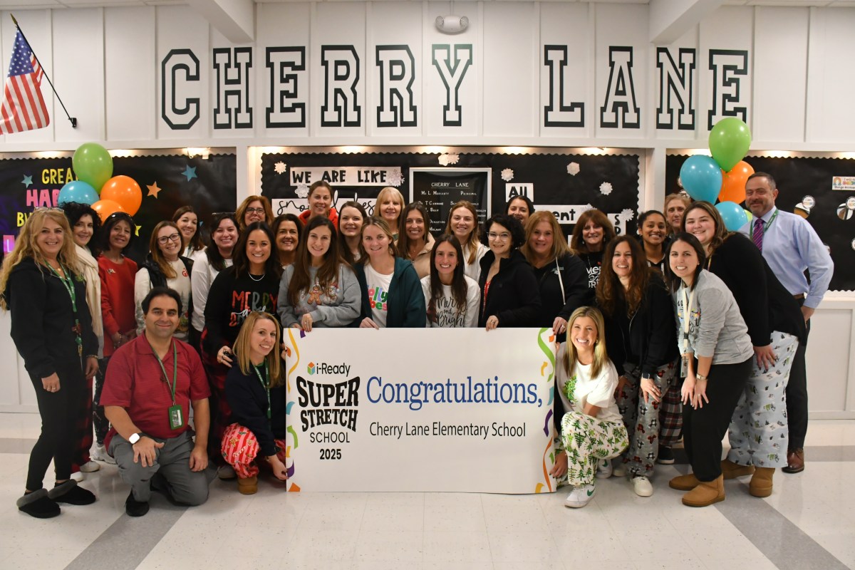 Cherry Lane teachers, Principal Moriarty and Superintendent Ted Cannone held a congratulatory banner for Cherry Lane’s super stretch accomplishments.