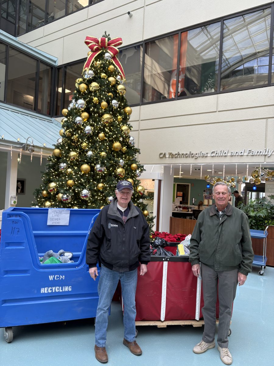 Richard Law (L.) and Jim Stipp (R.) delivered two full bins of toy donations to Cohen Children Medical Center.