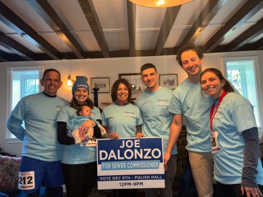 Jospeh D'Alonzo with his family and campaign sign for sewer commissioner.